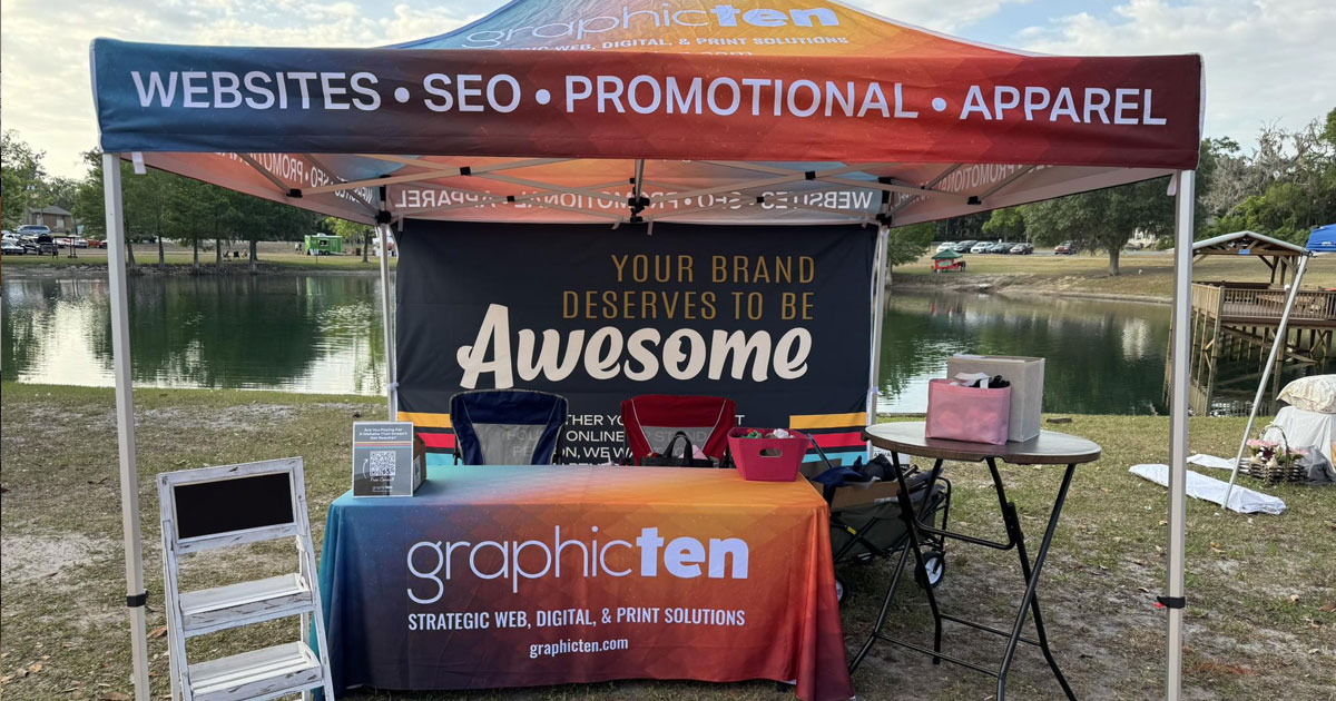 Custom booth with tent, tablecloth, and promotional items